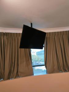 a window with a flat screen tv on top of it at Blenz Hotel in Serdang