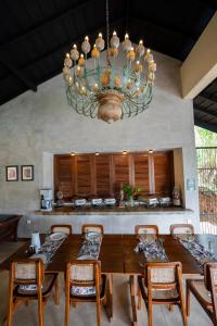 a dining room with a table and a chandelier at Ella Nine Peaks in Ella