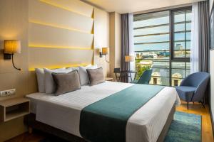 Ένα ή περισσότερα κρεβάτια σε δωμάτιο στο Leonardo Hotel Bucharest City Center