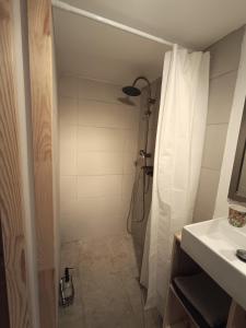 a bathroom with a shower with a shower curtain at La Parenthese 