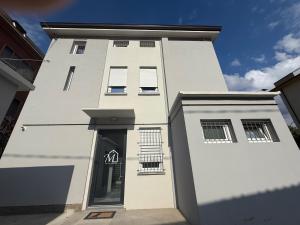 a white building with a door and windows on it at Da Marianna in Castelnuovo Rangone +3 photos