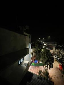 a night view of a building with a swimming pool at Hotel Aastha in Bhopal