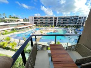 a view of a pool from the balcony of a resort at MALIA BEACH - Alto Padrão - PRAIA MURO ALTO - Porto de Galinhas in Porto De Galinhas +17 photos