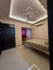a bedroom with a bed and a ceiling at Friends Apartment in Raipur