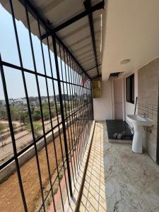 a room with a sink and a window with a view at Friends Apartment in Raipur