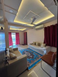 a living room with a couch and a rug at Friends Apartment in Raipur