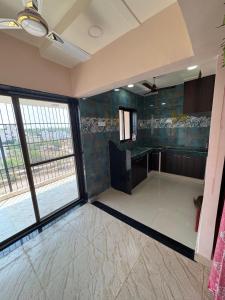 a large room with a bathroom with a large window at Friends Apartment in Raipur