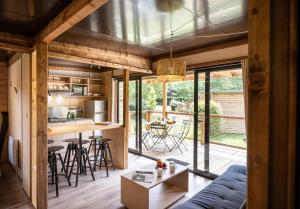an open kitchen and living room with a blue couch at Huttopia Arcachon in Arcachon