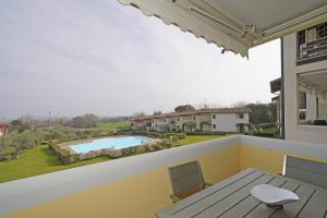 a balcony with a table and a view of a pool at Blu Garda View in Polpenazze del Garda