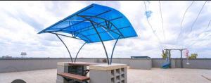 a blue umbrella sitting on top of a picnic table at Aggy Cozy homes in Syokimau +2 photos