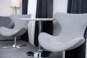 two chairs and a table in a room at Hotel Felicia in Rīga +39 photos