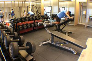 a man working out in a gym with weights at KLCC Pavilion Bukit Bintang Agile Hornbill Suites TRX in Kuala Lumpur
