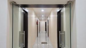 a hallway with glass doors and a walk way at Samriddhi Homestay in Varanasi