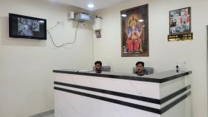 two men sitting at a bar in a room at Samriddhi Homestay in Varanasi