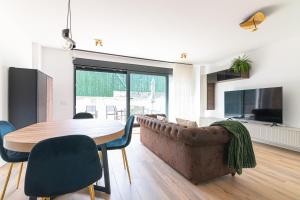 un soggiorno con un tavolo e un divano di La Casa Dorada a Santander