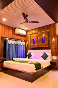 a bedroom with two beds and a ceiling fan at Hotel Highness Sea Rock in Neil Island +18 photos