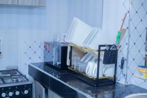 a kitchen with a coffee maker on a counter at Urban Nest suites in Kisii +3 photos