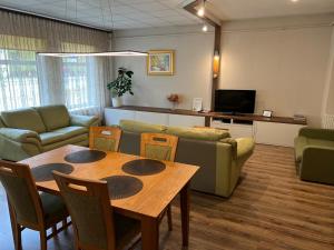 a living room with a table and a couch at RIGA street Apartment 54 entire house in Valmiera