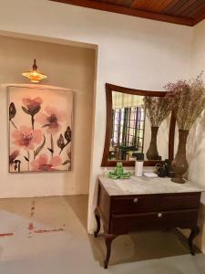 a dressing room with a mirror and a dresser and a dresser with at Chic Designer Master Bedroom in Shared Bungalow near LRT SS1 PJ in Petaling Jaya
