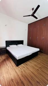a bedroom with a bed and a ceiling fan at Vardaan Luxury Villa in Mohali