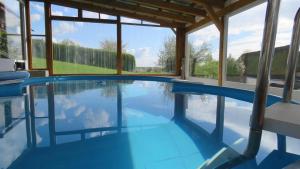 a swimming pool in a house with blue water at Das blaue Haus in Pleisweiler-Oberhofen
