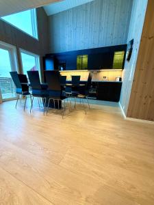 a dining room with a table and chairs on a wooden floor at KB Fisherman Cabin - NR3 - Stamsund in Stamsund