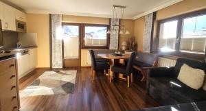 a living room with a table and a couch at Appartements Kuprian in Längenfeld