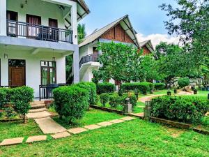 a house with a garden in front of it at Ranweli Resort Anuradhapura in Anuradhapura +44 photos
