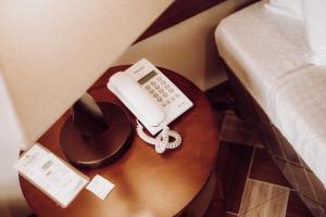 a phone on a table next to a bed at Lenma Family Inn in Davao City