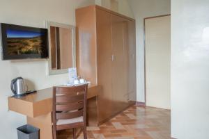 a kitchen with a desk and a chair in a room at Lenma Family Inn in Davao City