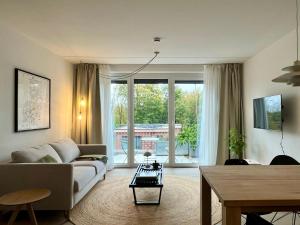 a living room with a couch and a table at Design Color Apartments Leer in Leer
