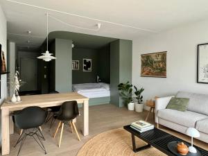 a living room with a table and a couch at Design Color Apartments Leer in Leer