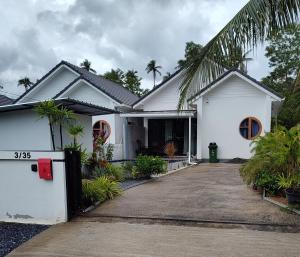 een wit huis met een oprit ervoor bij Waan Samui Pool Villa in Taling Ngam Beach