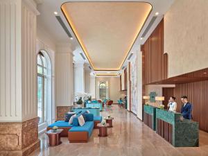 a lobby of a hotel with blue couches at Mercure Nha Trang Beach in Nha Trang