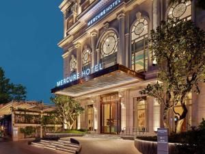 a large building with a sign that reads hermite hotel at Mercure Nha Trang Beach in Nha Trang +86 photos