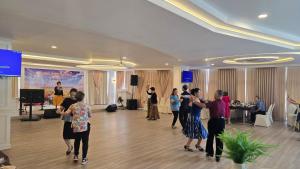 a group of people dancing in a room at Grand Tara Garden Thai Hotel in Bangkok +131 photos