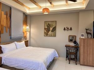 Postel nebo postele na pokoji v ubytování 微風森活 Whispering Breeze Villa