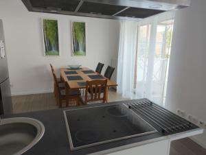 a kitchen with a table and a dining room at FeWo-Roman in Munster im Heidekreis +11 photos