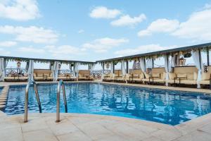 a pool at a hotel with chairs and tables at Hotel Imperial Plaza & Spa in Marrakech