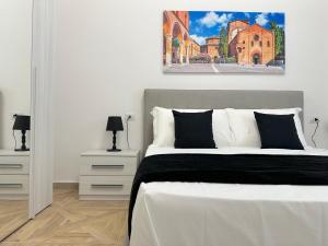 a bedroom with a bed and a painting on the wall at Amelia House in Bologna