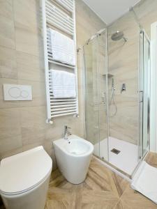 a bathroom with a toilet and a sink and a shower at Amelia House in Bologna