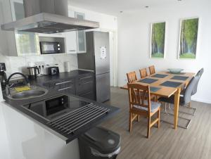 a kitchen with a table and a dining room at FeWo-Roman in Munster im Heidekreis