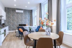 a living room with a table and chairs at Spacious Apartment in Tilburg Bed and Coffe in Tilburg