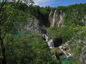 a waterfall in a canyon with trees at Guesthouse Zafran in Smoljanac