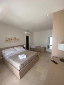 a bedroom with a large bed in a room at B&B La Porta sul Mare a Porto Cesareo in Torre Squillace +24 photos