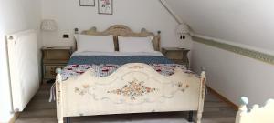 a bedroom with a bed with a floral bedspread at Golf Hotel Carezza in Carezza al Lago