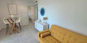 a living room with a couch and a table at Sea View Appartement Blue Monkey in Ifach