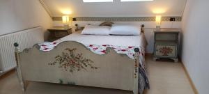 a bedroom with a bed and two night stands at Golf Hotel Carezza in Carezza al Lago