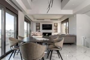 a living room with a table and chairs at Aetheria Luxury Villa in Kalithies