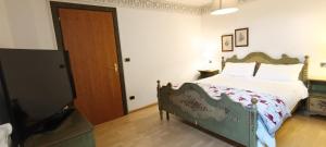 a bedroom with a bed and a wooden door at Golf Hotel Carezza in Carezza al Lago +29 photos